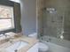 Bathroom featuring a shower over tub with glass door and granite countertops at 6832 Shangrila Way, Riverdale, GA 30296