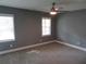 Neutral bedroom with a ceiling fan and two windows at 6832 Shangrila Way, Riverdale, GA 30296