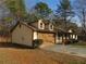 Beige single story house with brown trim and a two car garage with an attached front porch at 6832 Shangrila Way, Riverdale, GA 30296