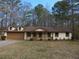 Charming single-story home featuring a well-manicured front lawn and an attached two car garage at 6832 Shangrila Way, Riverdale, GA 30296