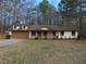 Charming single-story home featuring a well-manicured front lawn and an attached two car garage at 6832 Shangrila Way, Riverdale, GA 30296