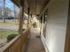 A long front porch with wooden railing and supports extends across the facade of the house at 6832 Shangrila Way, Riverdale, GA 30296
