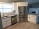 Bright kitchen with stainless steel appliances, white cabinetry, and granite countertops at 6832 Shangrila Way, Riverdale, GA 30296