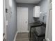 Functional laundry room with washer, dryer, and wire shelving at 6832 Shangrila Way, Riverdale, GA 30296