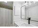 Modern bathroom featuring quartz countertops, and a framed rectangular mirror with modern lighting at 2106 Clairmeade Valley Ne Rd, Atlanta, GA 30329