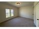 Cozy bedroom featuring neutral carpet, a window providing natural light, and a ceiling light at 2106 Clairmeade Valley Ne Rd, Atlanta, GA 30329