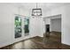 Bright dining room featuring wood floors, patio access, and modern lighting fixture at 2106 Clairmeade Valley Ne Rd, Atlanta, GA 30329