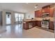 Open kitchen and dining area with stainless steel appliances and tile flooring at 3158 Onamia Rd, Duluth, GA 30096