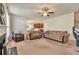 Inviting living room featuring neutral tones, ceiling fan, and plush seating for a cozy and comfortable atmosphere at 3158 Onamia Rd, Duluth, GA 30096