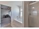 Bright main bathroom with shower, soaking tub, and views into the large main bedroom, creating a spa-like experience at 3158 Onamia Rd, Duluth, GA 30096