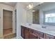 Well-lit main bathroom featuring double vanity, ample counter space, and separate shower, providing convenience and style at 3158 Onamia Rd, Duluth, GA 30096