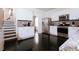 Modern kitchen with granite countertops, stainless steel appliances, white cabinets, and dark hardwood floors at 4617 Stone Lane, Stone Mountain, GA 30083