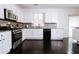 Bright kitchen featuring white cabinets, stainless steel appliances, granite countertops, and hardwood floors at 4617 Stone Lane, Stone Mountain, GA 30083