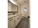 Bathroom with granite countertop, white cabinets and black hardware, complemented by tile flooring at 554 Presley Farm Parkway, Rockmart, GA 30153