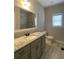 Bathroom featuring a long vanity with double sinks, granite countertops and tile flooring at 554 Presley Farm Parkway, Rockmart, GA 30153