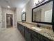 Modern bathroom featuring granite countertops, double sinks, decorative mirrors and tile floors at 554 Presley Farm Parkway, Rockmart, GA 30153