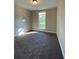 Neutral bedroom with a carpeted floor, a single window, and bright base molding at 554 Presley Farm Parkway, Rockmart, GA 30153