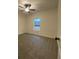 Carpeted bedroom with a window, ceiling fan, and neutral wall color at 554 Presley Farm Parkway, Rockmart, GA 30153