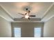 This bedroom features a ceiling fan and two windows that allow natural light to illuminate the space at 554 Presley Farm Parkway, Rockmart, GA 30153