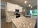 Well-equipped kitchen features stainless steel appliances, a stylish backsplash, and ample countertop space at 554 Presley Farm Parkway, Rockmart, GA 30153