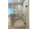 Modern shower with a glass door, built-in seat, tiled walls and tile flooring at 554 Presley Farm Parkway, Rockmart, GA 30153