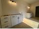 Bathroom featuring white vanities, modern lights, and a door to the toilet at 554 Presley Farm Pkwy, Rockmart, GA 30153
