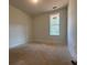 Bedroom with neutral walls, natural light, and a minimalist design at 554 Presley Farm Pkwy, Rockmart, GA 30153