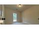 This is a light and airy bedroom with a window and a light on the ceiling at 554 Presley Farm Pkwy, Rockmart, GA 30153