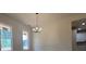 Cozy dining area with a modern chandelier and views of the kitchen and outdoor landscape at 554 Presley Farm Pkwy, Rockmart, GA 30153