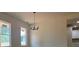 Bright dining room featuring two windows and a modern chandelier at 554 Presley Farm Pkwy, Rockmart, GA 30153