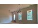 Bright dining room featuring two windows and a modern chandelier at 554 Presley Farm Pkwy, Rockmart, GA 30153