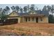 Charming, new construction, one-story home with vertical siding and dark roof in wooded setting at 554 Presley Farm Pkwy, Rockmart, GA 30153