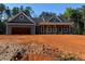 New home with a large garage and expansive front yard in a serene, wooded setting at 554 Presley Farm Pkwy, Rockmart, GA 30153
