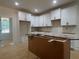 Kitchen features white cabinets and under-mount sink at 554 Presley Farm Pkwy, Rockmart, GA 30153