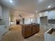 Open kitchen with island and adjoining living room with fireplace at 554 Presley Farm Pkwy, Rockmart, GA 30153