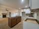Spacious kitchen with island and view into living room with fireplace at 554 Presley Farm Pkwy, Rockmart, GA 30153