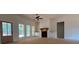 Living room with a fireplace, built-in cabinets and a view of the outdoors through large windows at 554 Presley Farm Pkwy, Rockmart, GA 30153