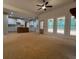 Spacious living room with an open kitchen, large windows, and a ceiling fan at 554 Presley Farm Pkwy, Rockmart, GA 30153