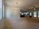 Open-concept living room with views of the kitchen, backyard, and modern lighting fixtures at 554 Presley Farm Pkwy, Rockmart, GA 30153