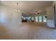 Spacious living room featuring modern lighting, abundant natural light, and a view of the open kitchen at 554 Presley Farm Pkwy, Rockmart, GA 30153