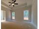 Spacious main bedroom with tray ceiling, ceiling fan, and two windows at 554 Presley Farm Pkwy, Rockmart, GA 30153