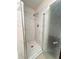 Bathroom shower features glass doors and marble tiling at 1418 Brookside Manor Ct, Tucker, GA 30084