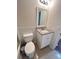 Updated bathroom features a modern vanity with granite countertop and white cabinetry at 1418 Brookside Manor Ct, Tucker, GA 30084