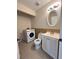 Bathroom features a white vanity, toilet, and a Samsung washing machine, offering convenience and functionality at 1418 Brookside Manor Ct, Tucker, GA 30084