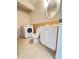 A bathroom featuring a washing machine, vanity with storage, and toilet with tile flooring at 1418 Brookside Manor Ct, Tucker, GA 30084