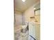 Bathroom featuring a marble-style tile shower, toilet, and vanity with storage at 1418 Brookside Manor Ct, Tucker, GA 30084