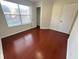 This bedroom features natural light, neutral paint, wood floors, and a closet at 1418 Brookside Manor Ct, Tucker, GA 30084