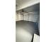 An empty garage with a newly painted floor and a closed garage door at 1418 Brookside Manor Ct, Tucker, GA 30084