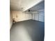 Spacious garage with a gray epoxy floor and a white garage door, perfect for parking and storage at 1418 Brookside Manor Ct, Tucker, GA 30084