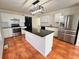 Modern kitchen with stainless steel appliances and a central island with granite countertop at 1418 Brookside Manor Ct, Tucker, GA 30084